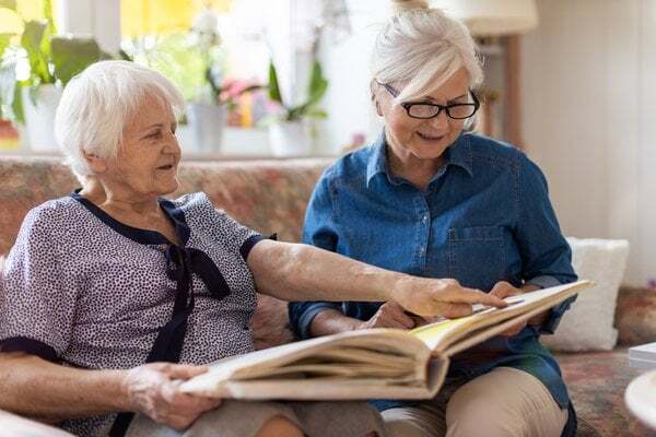 memory-care-senior-women-reading-photo-album-1
